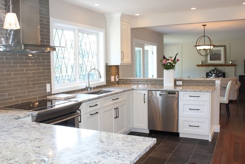White Ice Granite with White Cabinets and Dark Color Flooring and Stainless Steel Appliance . Backsplash is Moda Glass Subway.